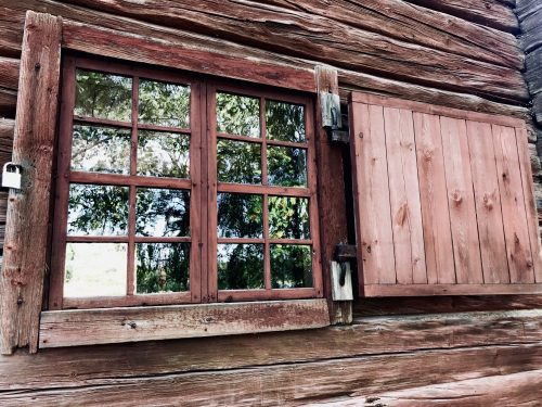 Red wooden cottage with worn surface